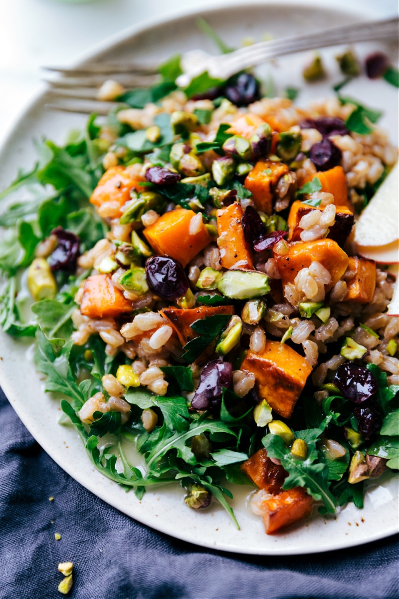 A delicious salad loaded with grains, fresh veggies, and topped with a flavorful dressing.