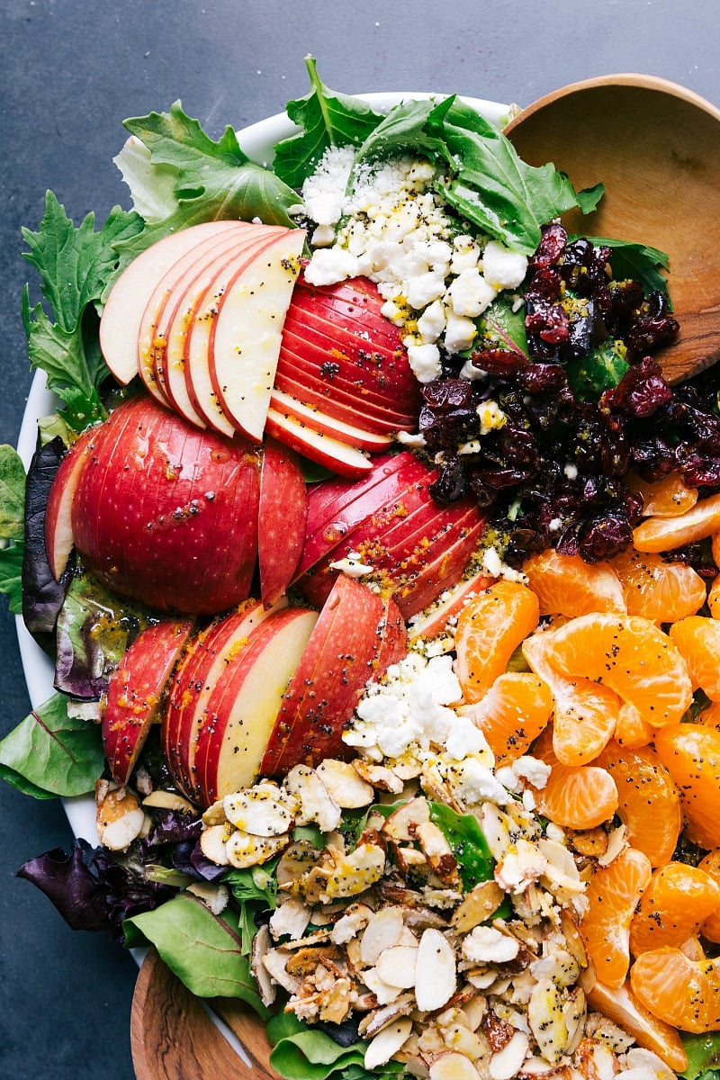 Overhead view of the apples, feta, cranberries, mandarin oranges and candied almonds that top this scrumptious salad.