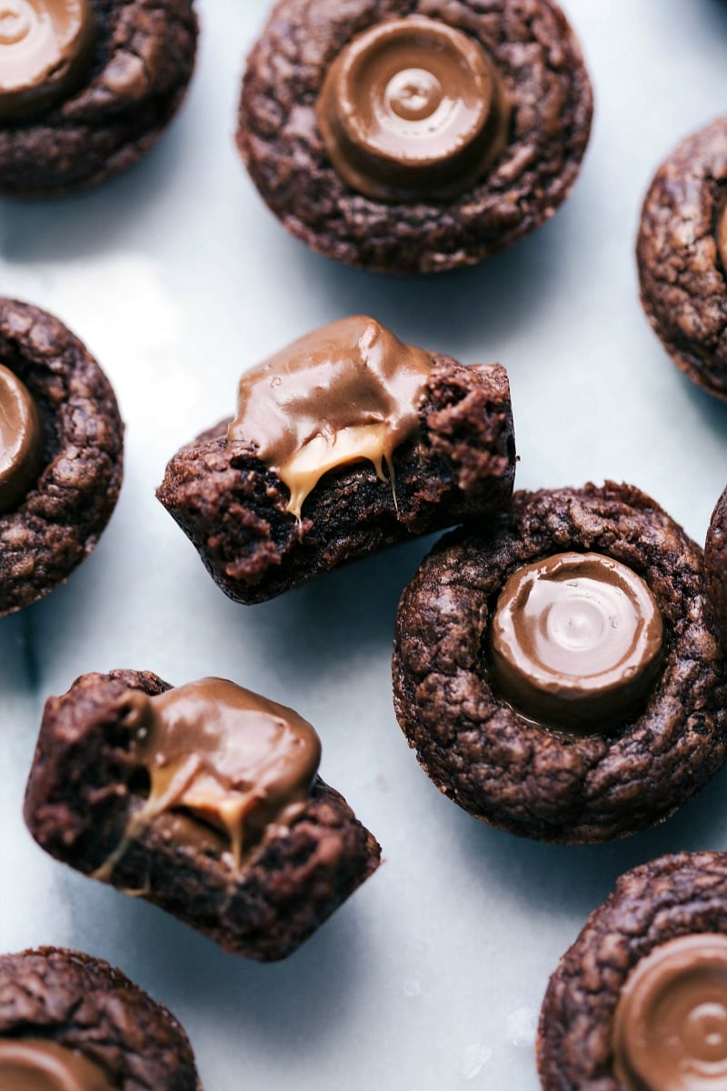 Close-up view of Mini Brownie Bites with Rolos; one is cut in half to expose the gooey, melty insides.