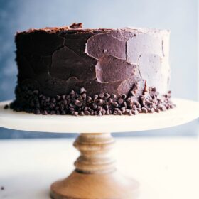 A finished and gorgeous banana chocolate chip cake on a cake stand.