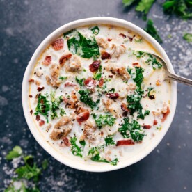A bowl of easy Zuppa Toscana soup topped with fresh herbs.