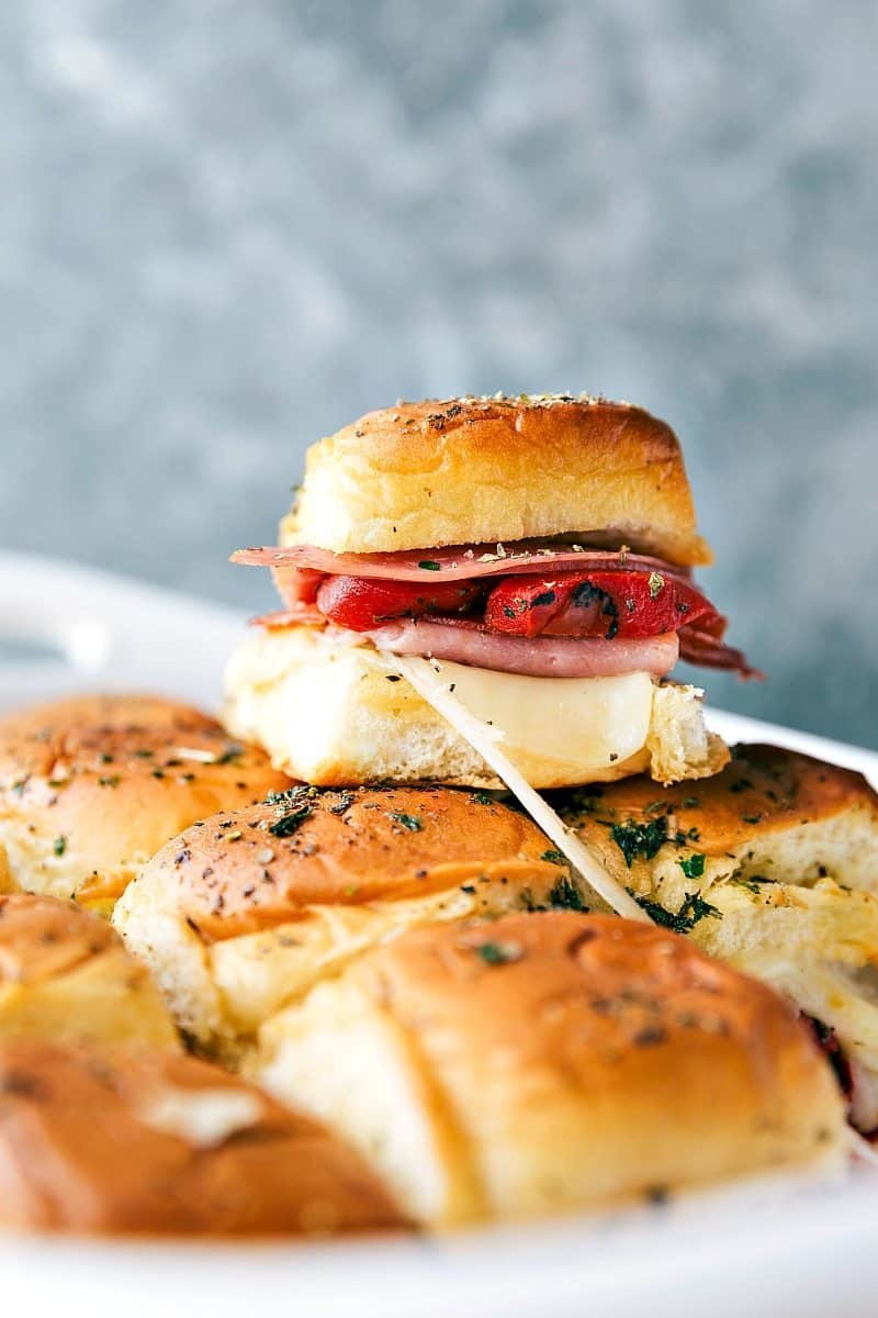 EASY BAKED ITALIAN SLIDERS! Easy baked Italian sliders with ham, salami, pepperoni, roasted red peppers, and provolone. These sliders are so quick, easy, and make the perfect appetizer! via chelseasmessyapron.com