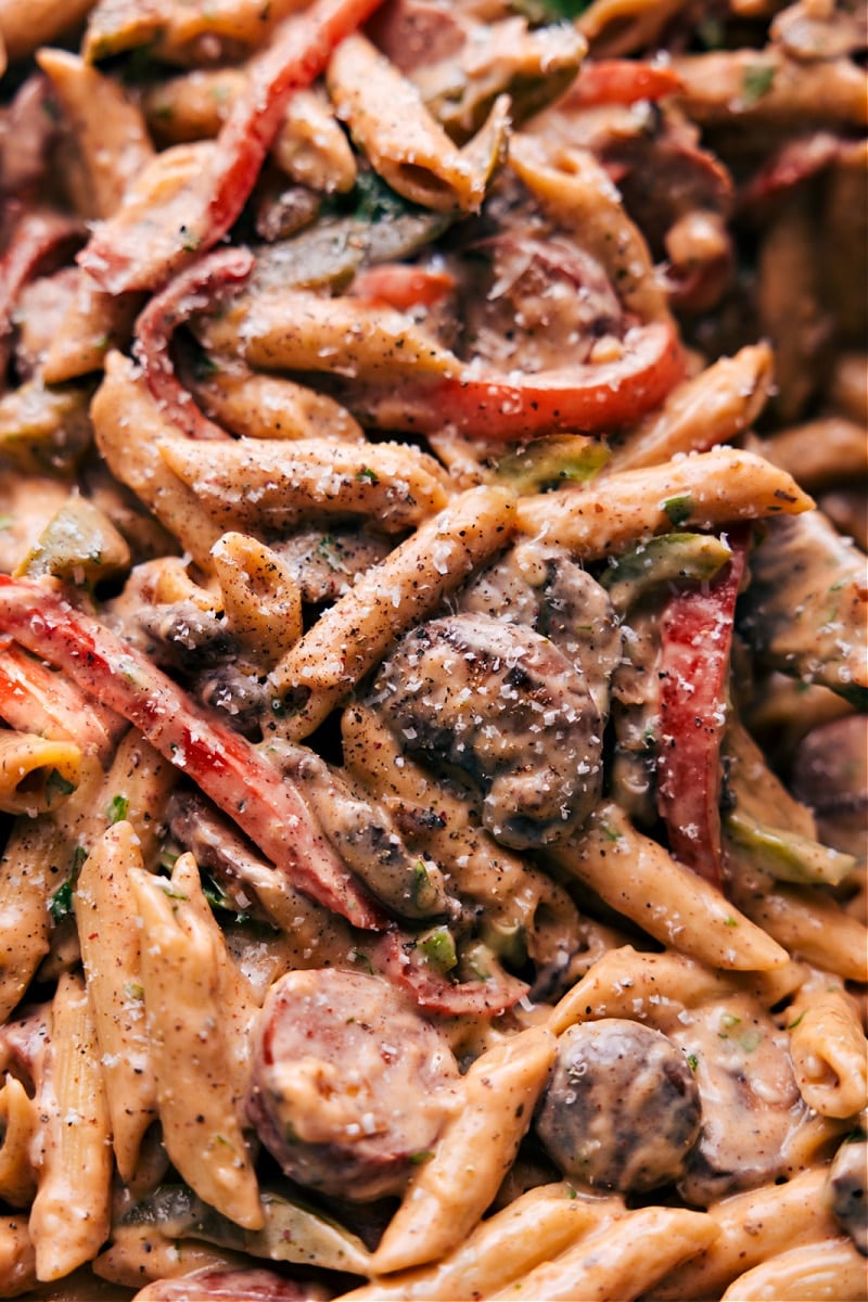 This Cajun Sausage Pasta is deliciously creamy, perfectly spiced, and deeply savory. Plus, we've made it a little bit lighter -- no heavy cream needed! Recipe via ChelseasMessyApron.com #smokedsausage #andouille #pasta #alfredo #creamcheese #lighter #cajun Close-up view of Cajun Sausage Pasta!