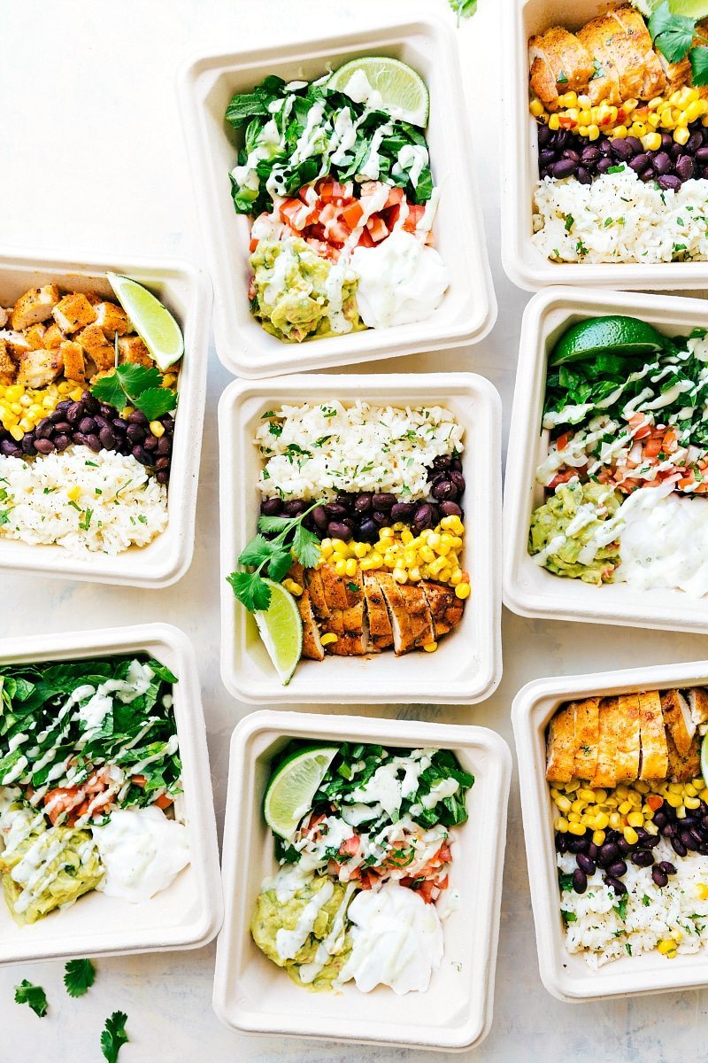 EASY MEAL PREP Chicken Burrito Bowls!! Tons of short-cuts for a better than a restaurant burrito bowl! Taco-seasoned chicken, cilantro-lime rice, salsa, guac, beans, and a creamy cilantro sauce! Recipe via chelseasmessyapron.com