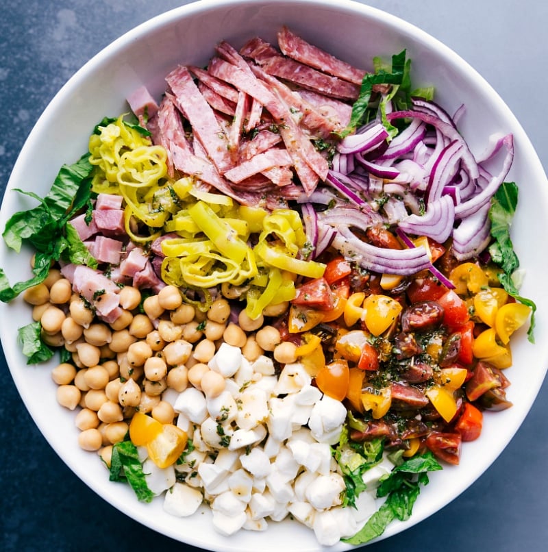 Salami, vegetables, and garbanzo beans layered over crisp lettuce.