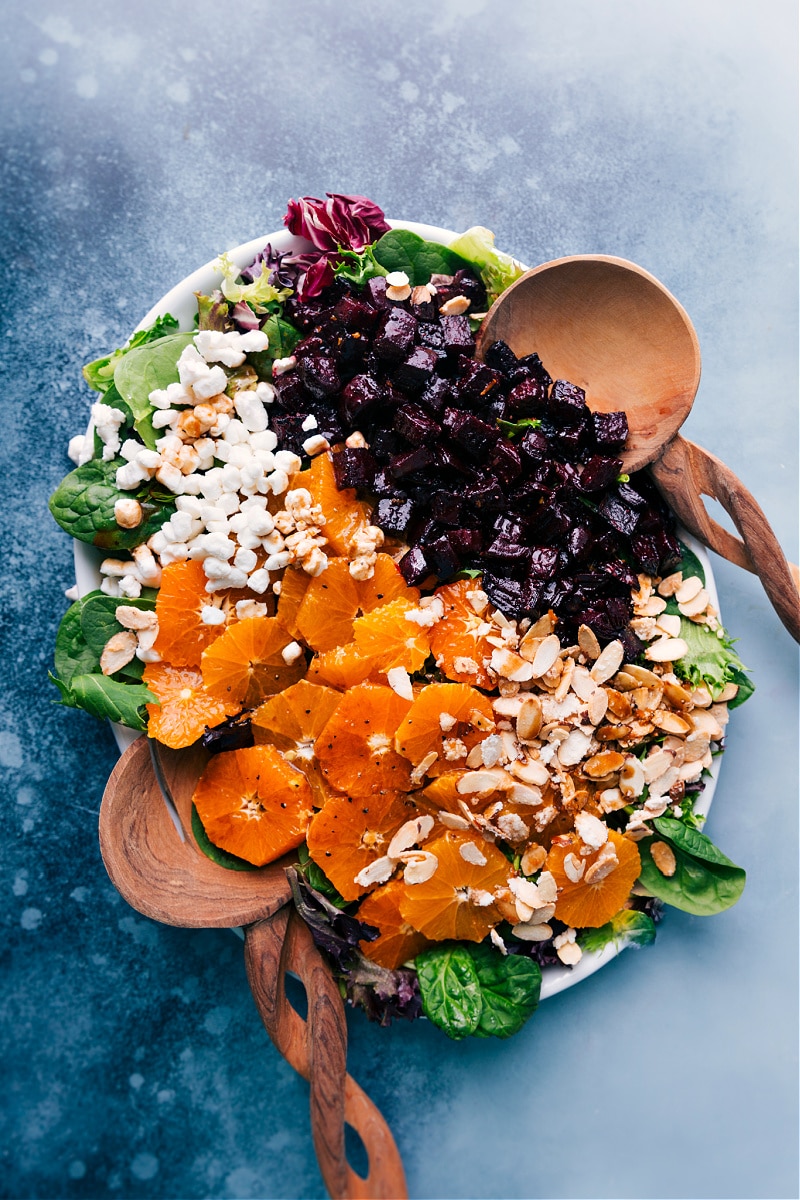 Here's our favorite Beet Salad, complete with perfectly caramelized roasted beets, fresh citrus, creamy goat (or feta) cheese, and sweet, candied almonds. Add a drizzle of our favorite tangy citrus-balsamic vinaigrette to perfectly finish everything off! Recipe via chelseasmessyapron #dinner #side #best #quick #vegetarian #oranges #sliveredalmonds #goatcheese #healthy #beet #salad Beet Salad overhead view