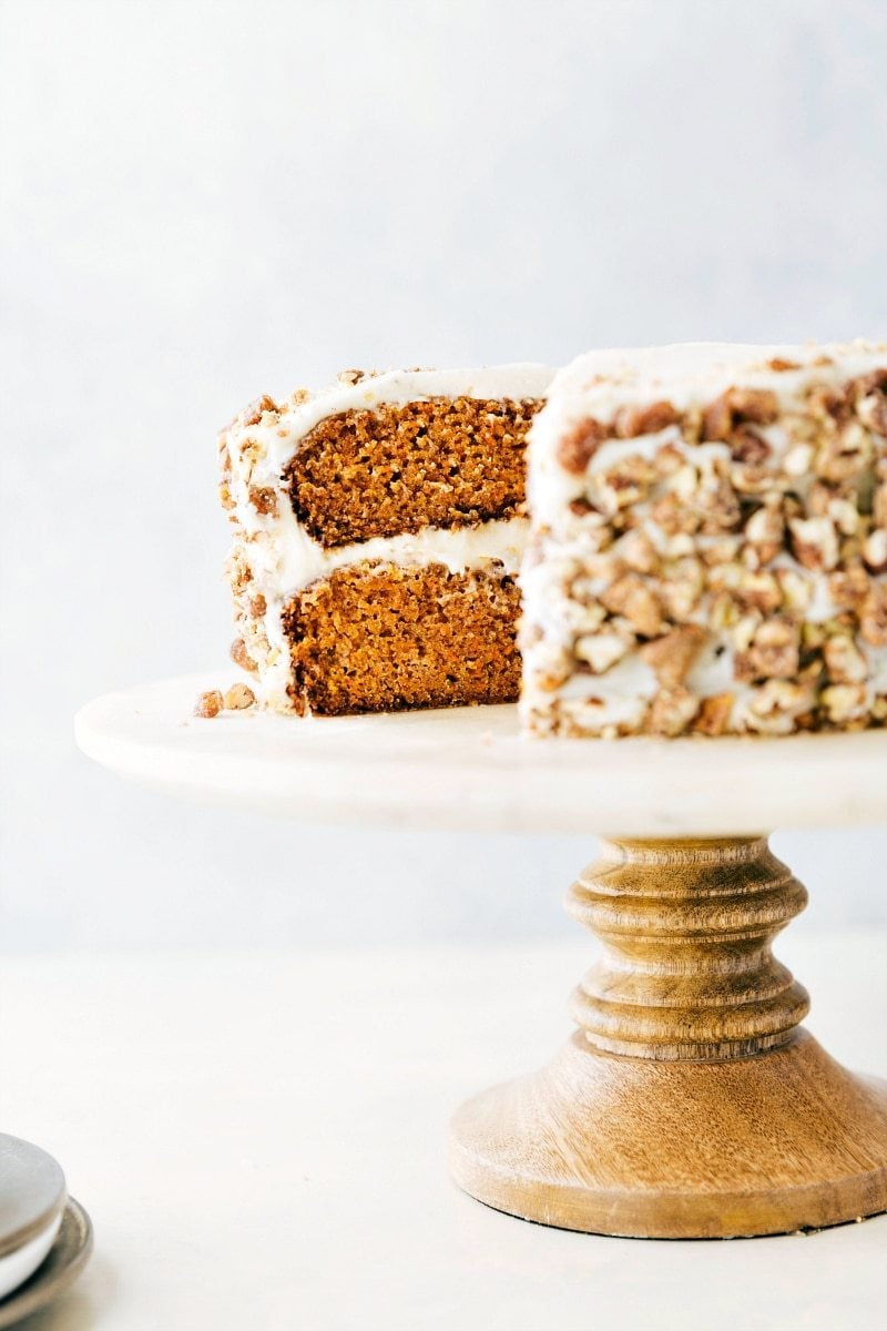 This is our favorite Carrot Cake recipe of all time! It's incredibly moist and perfectly spiced with a delicious tangy cream cheese frosting. Decorate the cake with candied pecans to give it an extra delicious finish touch! Recipe via ChelseasMessyApron #dessert #best #quick #easy #simple #easter #candiedpecans #layers #carrotcake Carrot Cake on a cake stand