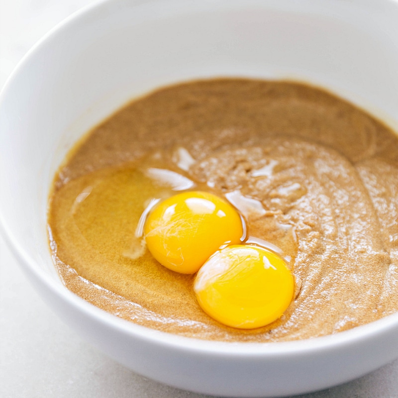 Image of eggs being added to the wet ingredients for this Flourless Monster Cookie recipe.