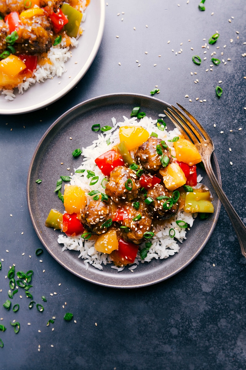 Overhead image of Sweet and Sour Meatballs with rice, on a plate.