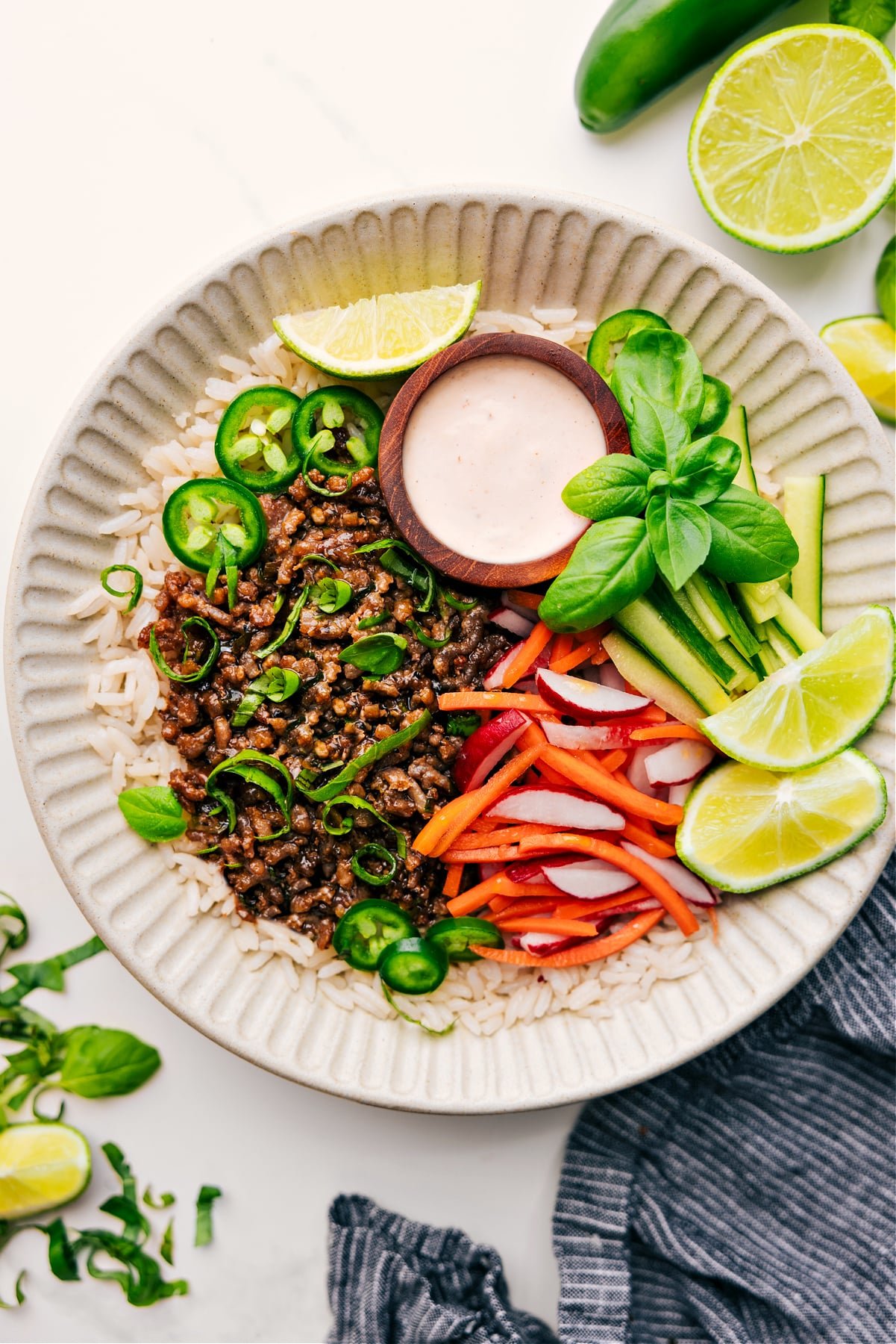Delicious And Flavorful Banh Mi Bowls Banh Mi Bowls on a bed of rice, served with a side of cucumber, pickled carrot, and radish salad, along with a tasty sauce on the side.