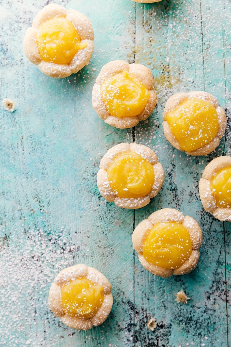 Four simple themed "Flower Treats" that are perfect for Mother's Day or Spring celebrations! Rose Cake Pops, Lemon Curd Cookie Cups, Flower Cookie Pops, & Sunflower Nutella Frosting Bites. via chelseasmessyapron.com