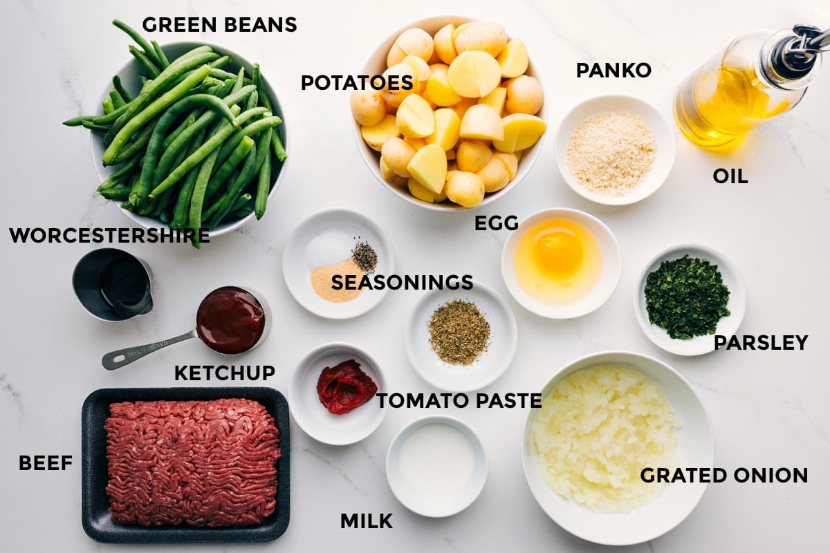 Sheet Pn Meatloaf Ingredients All the ingredients for this recipe prepped and ready for easy assembly including green beans, Worcestershire sauce, ketchup, ground beef, milk, tomato paste, seasonings, grated onion, parsley, egg, potatoes, panko, and oil.