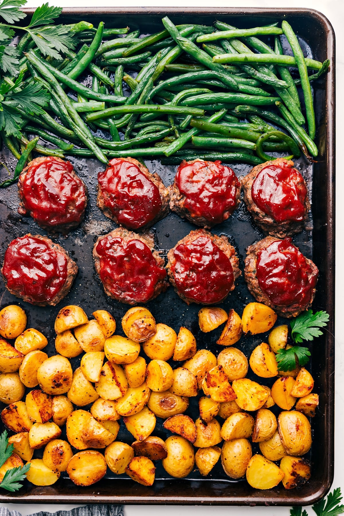Mini Meatloaf All Made On One Pan Sheet Pan Meatloaf with roasted green beans and potatoes cooked together on one pan for an easy complete dinner.