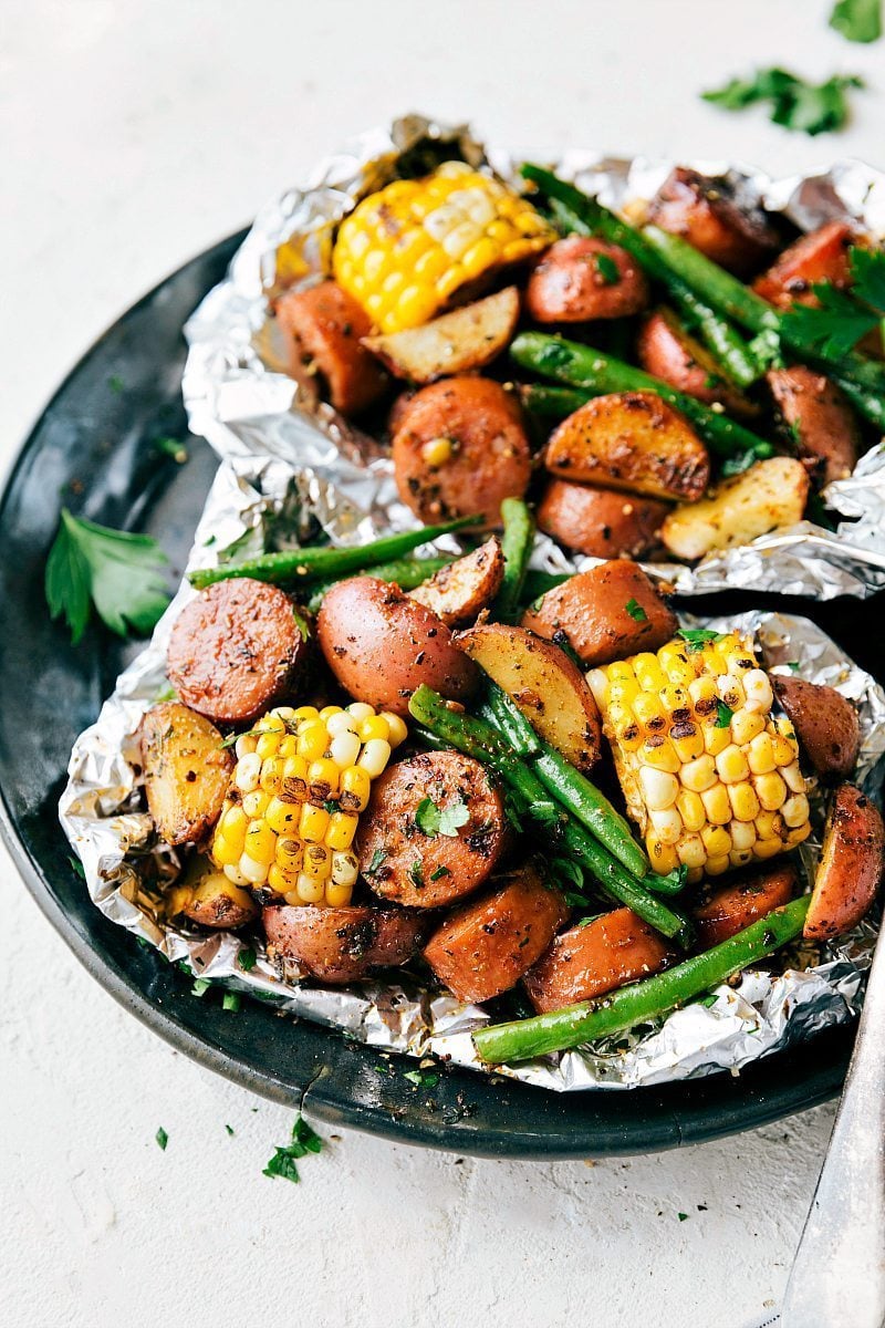 Foil Pack Sausage and Veggies! Easy Tin Foil Pack Garlic Butter Sausage and Veggies. A delicious meal that takes 15 minutes prep time or less! chelseasmessyapron.com