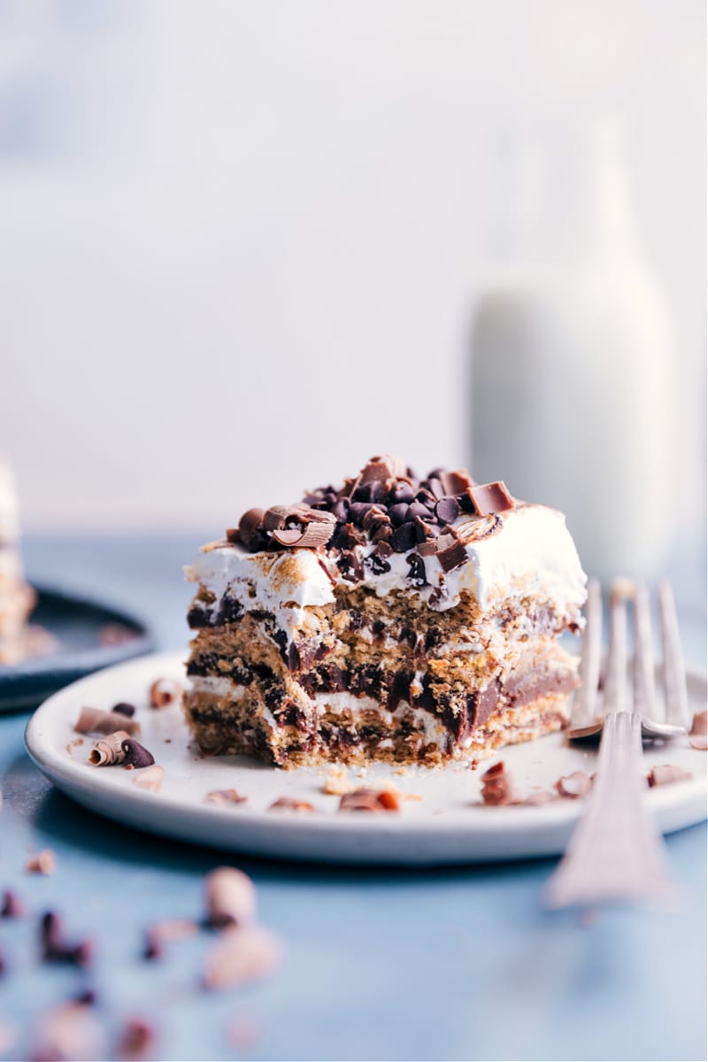 Image of a square of the S'mores Icebox Cake on a plate with a bite being taken out of it
