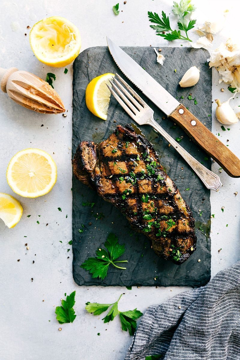 Steak on a cutting board after being cooked in the best Steak Marinade