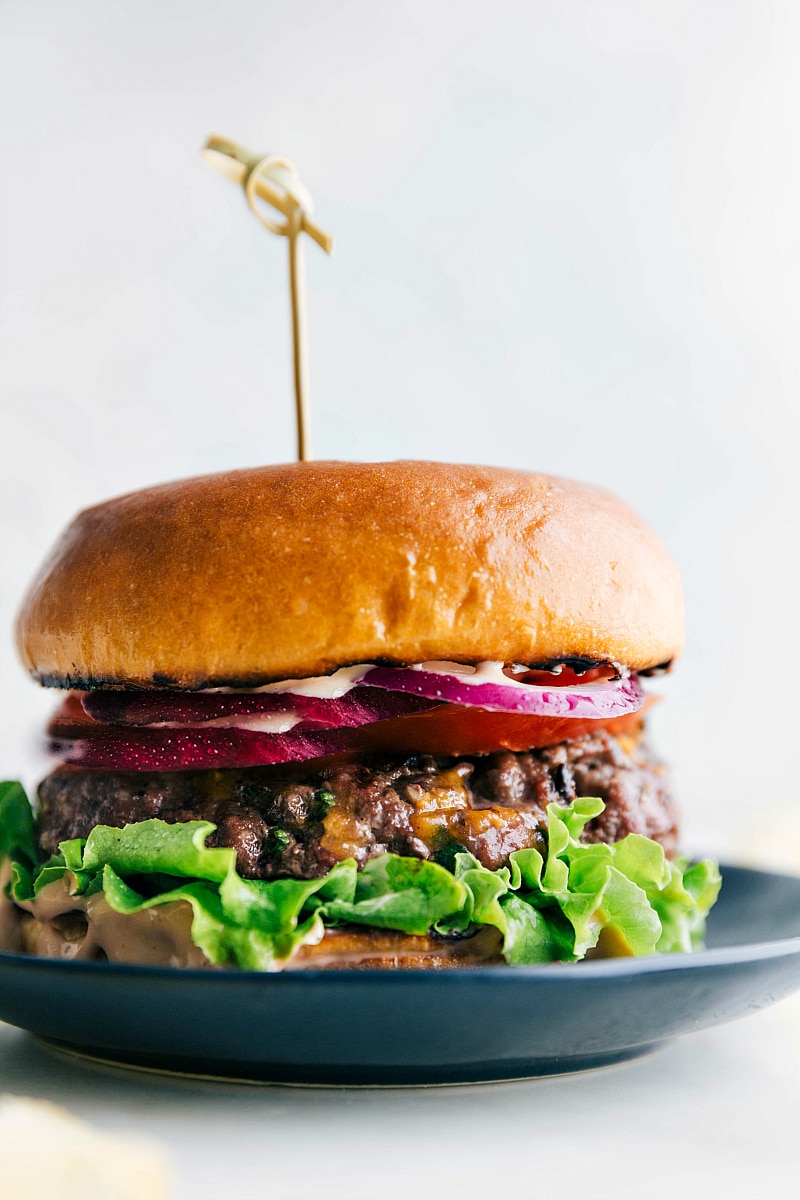 A mouthwatering burger created from this burger recipe, featuring a juicy patty sandwiched between soft buns, topped with a variety of delicious toppings.