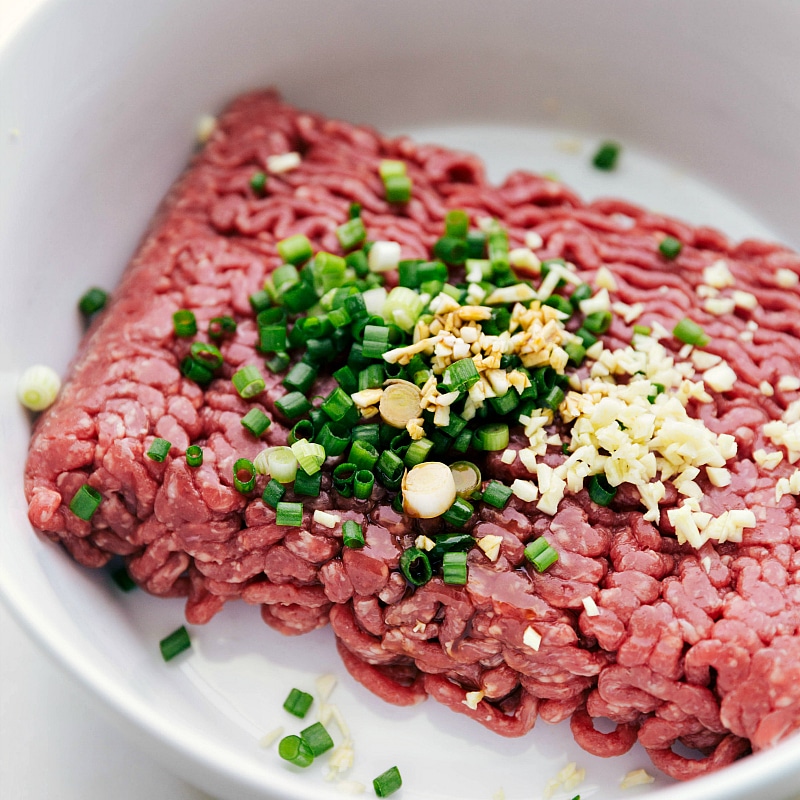 Process shot-- Image of the ground beef with the diced seasonings for this Burger Recipe.