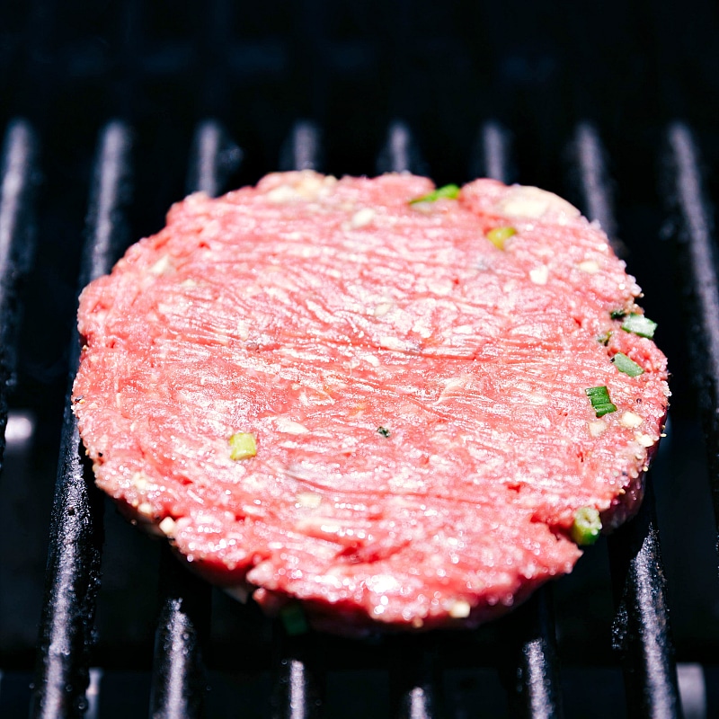 A beef patty sizzling on the grill, being cooked to perfection, ensuring a juicy and flavorful patty.