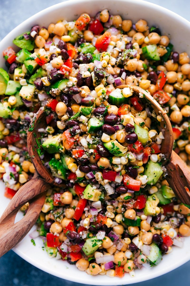 Overhead image of Garbanzo Bean Salad in a bowl with serving spoons