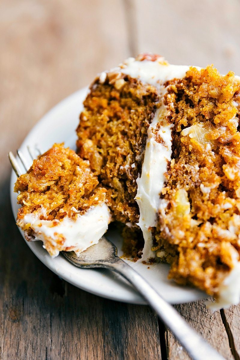 Up-close image of a slice of Pumpkin Carrot Cake with a bite coming out of it.