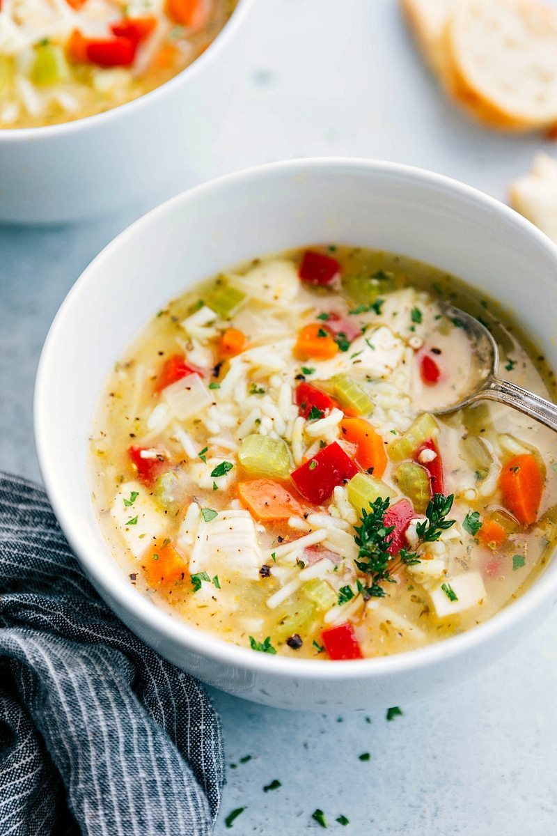 Hearty and delicious chicken and rice soup in a white bowl.