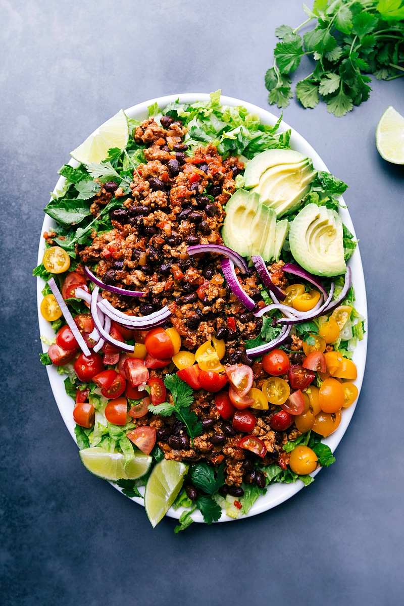 Ground turkey taco salad complete with a variety of fresh ingredients on top.