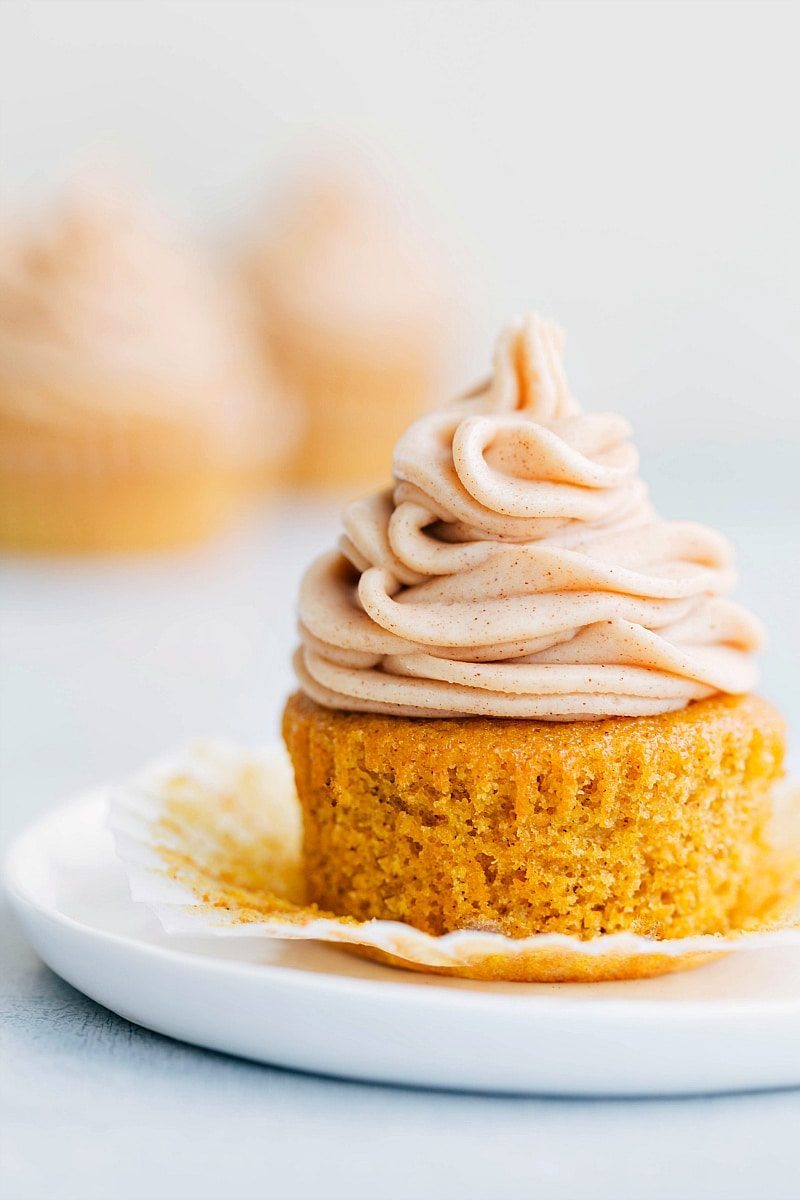 Finished moist pumpkin cupcake with a generous amount of frosting, delicious and ready to be enjoyed.