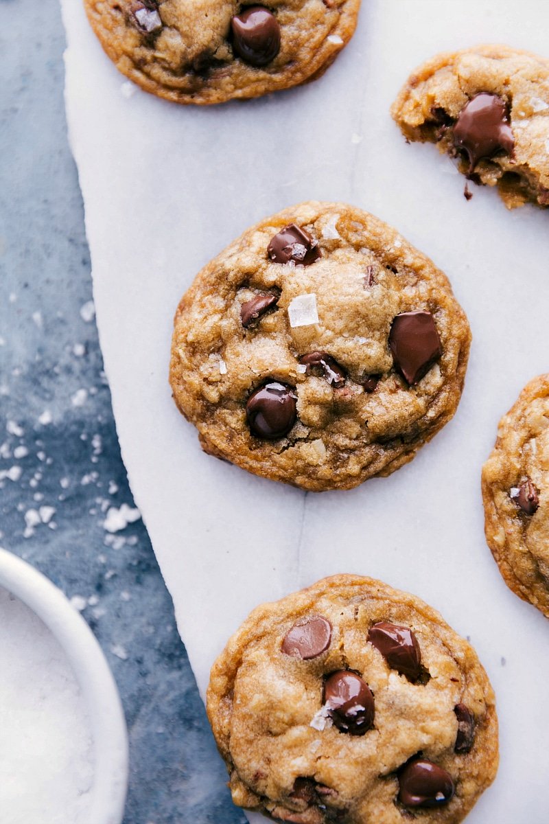 Overhead image of Brown Butter Chocolate Chip Cookies with sea salt sprinkled on top, ready to be eaten. 