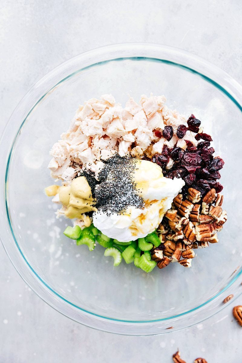 All the ingredients for Chicken Salad being combined in a bowl.