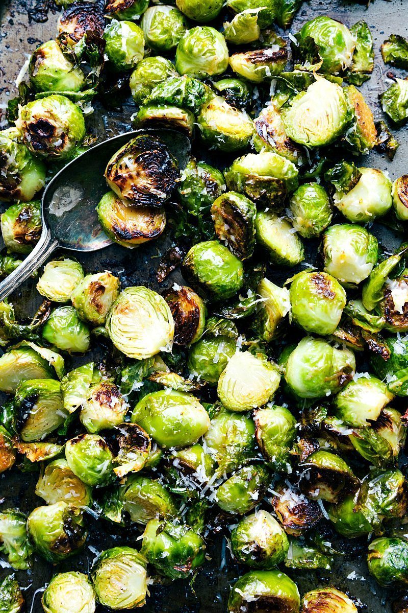 Up-close overhead image of the roasted Brussel sprouts on a sheet pan are part of this Thanksgiving Dinner.