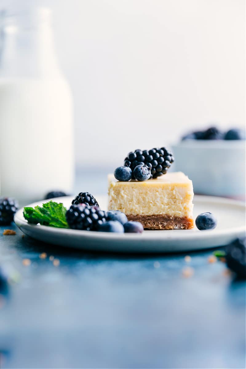 Image of a square of the cheesecake bars on a plate