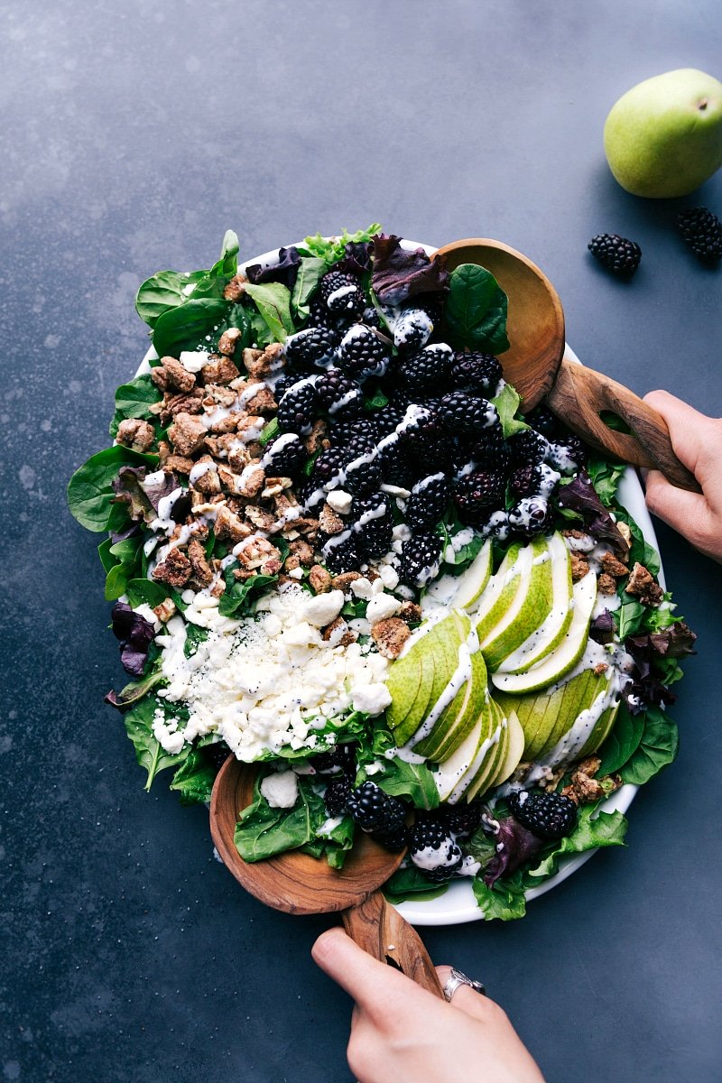 Overhead view of Blackberry Salad, drizzled with poppy seed dressing, ready to eat.