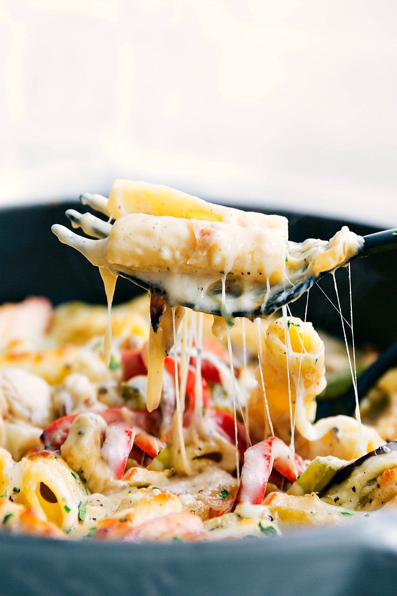 The ultimate BEST EVER baked pasta! Chicken "cheesesteak" creamy and cheesy baked pasta that is easy and SO delicious! via chelseasmessyapron.com |#chicken #cheesesteak #onions #peppers #pasta #baked #dinner #easy #quick #familyfriendly #comfortfood #bakedpasta #creamy