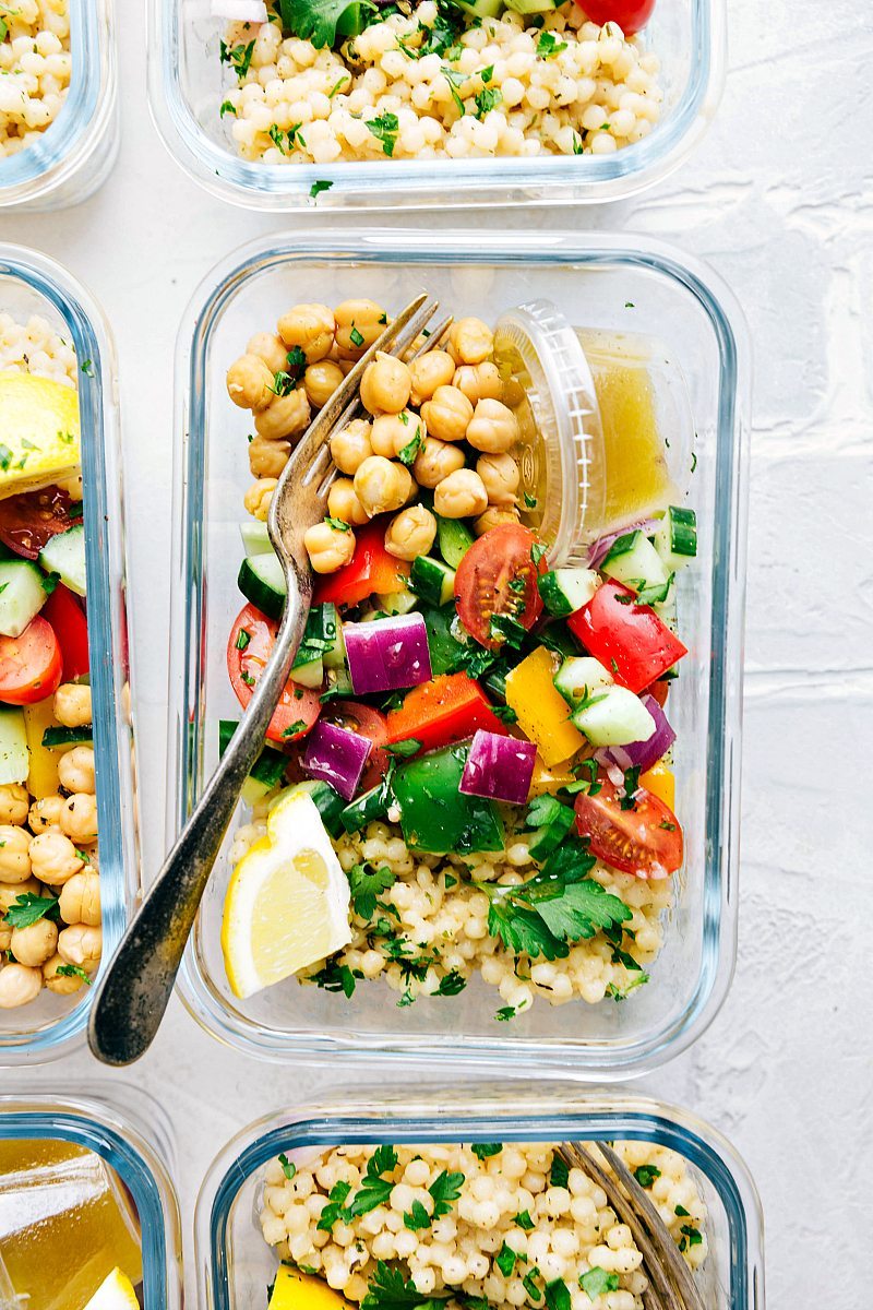Greek couscous salad in a glass container for lunch.