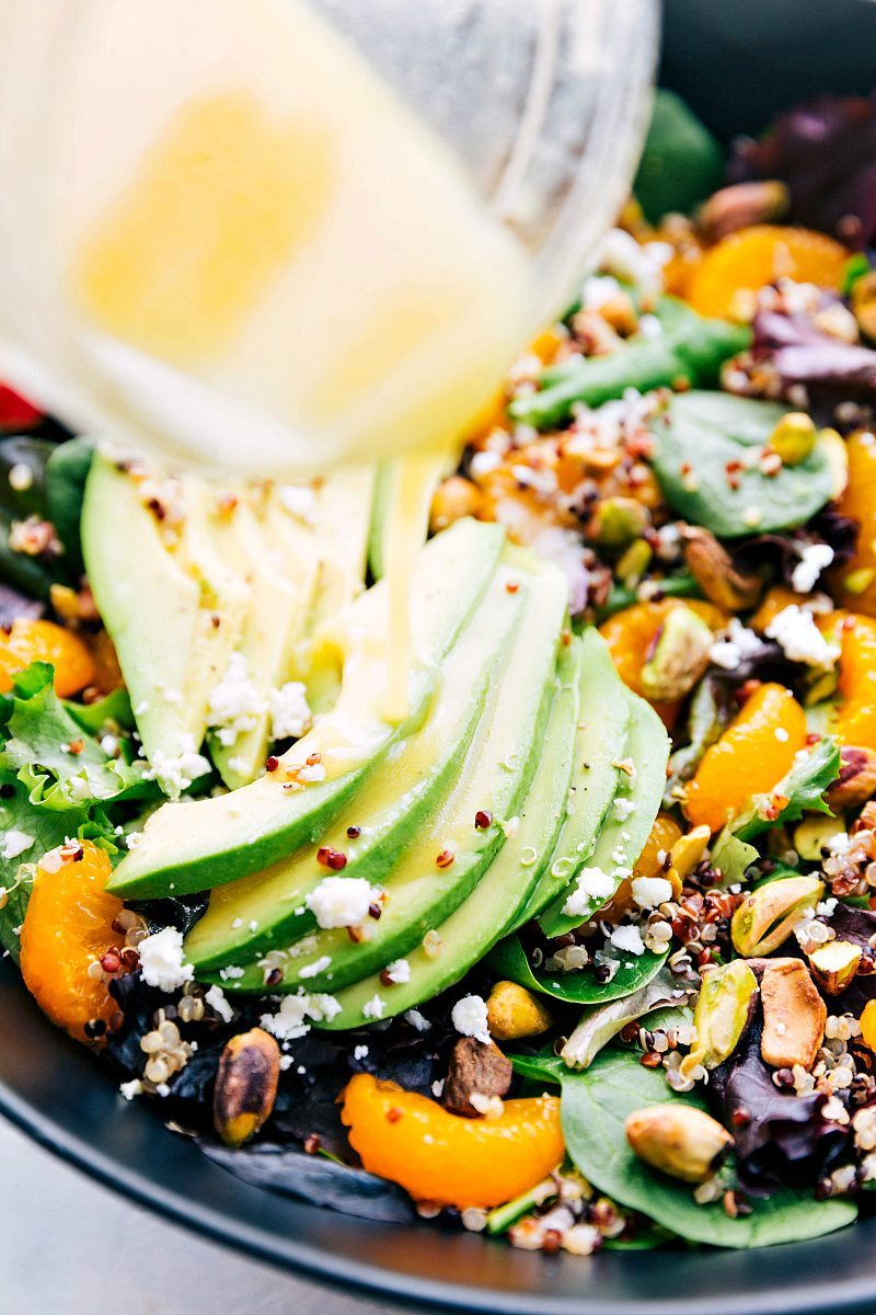 Up-close image of the dressing being poured over the Citrus Quinoa Salad.