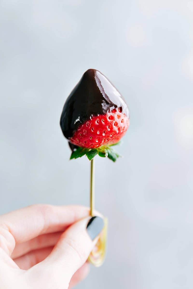 Finished chocolate fondue coating a strawberry