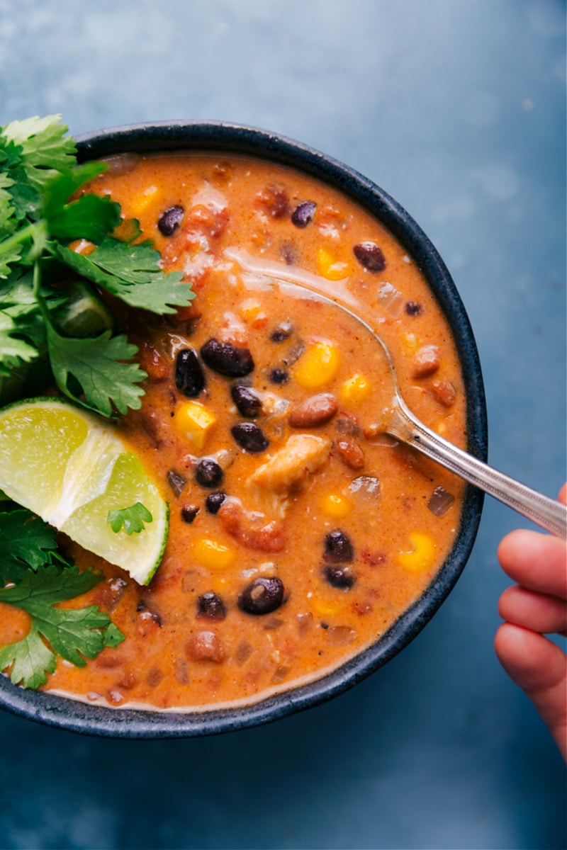 Overhead image of Chicken Tortilla Soup in a bowl with a spoonful being taken out