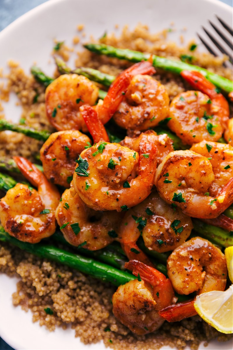 Lemon Garlic Shrimp on a plate with couscous and asparagus