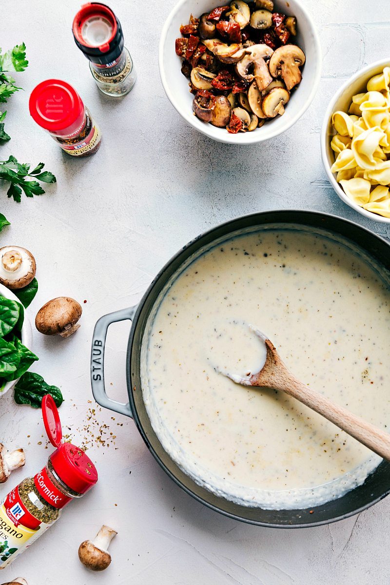 ONE SKILLET creamy chicken, sundried tomatoes, and tortellini. Healthier ingredients and all the flavor! via chelseasmessyapron.com #skillet #chicken #oneskillet #easy #quick #dinner #tomato #sundried #tortellini #30minute #dinner #recipe #kidfriendly #mushroom