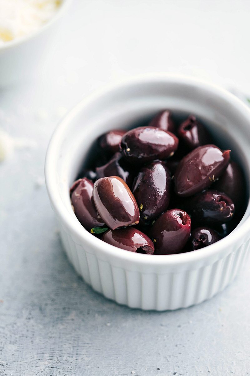 Kalamata olives in a white dish. 