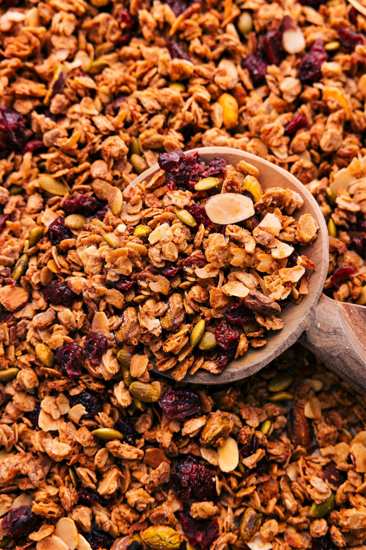 The Best Homemade Granola Recipe A big scoop of granola on the sheet pan, ready to enjoy.