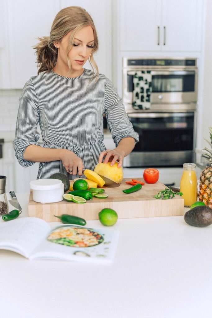 Chelsea chopping vegetables in her kitchen