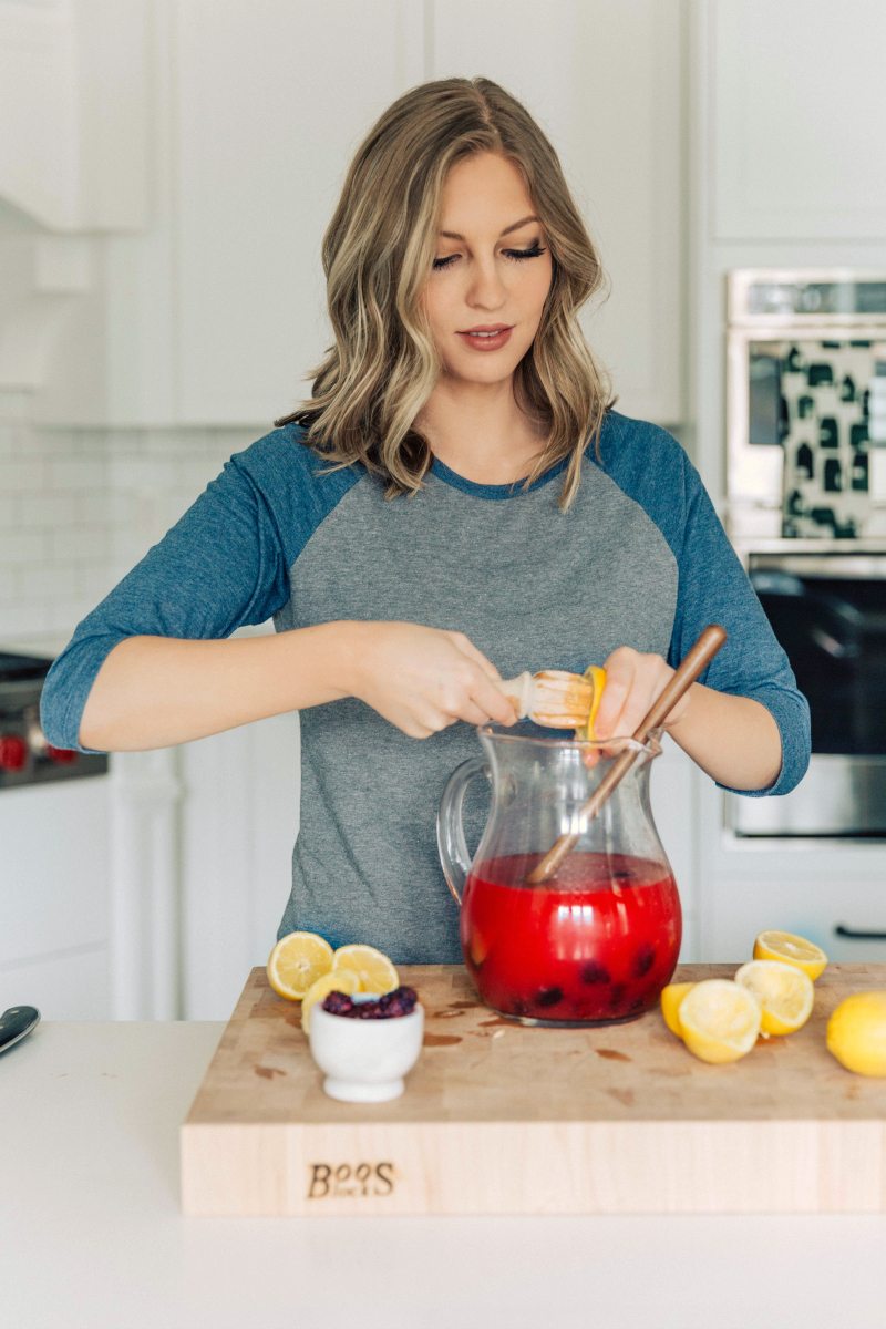 Author squeezing fresh lemons for Blackberry Lemonade.