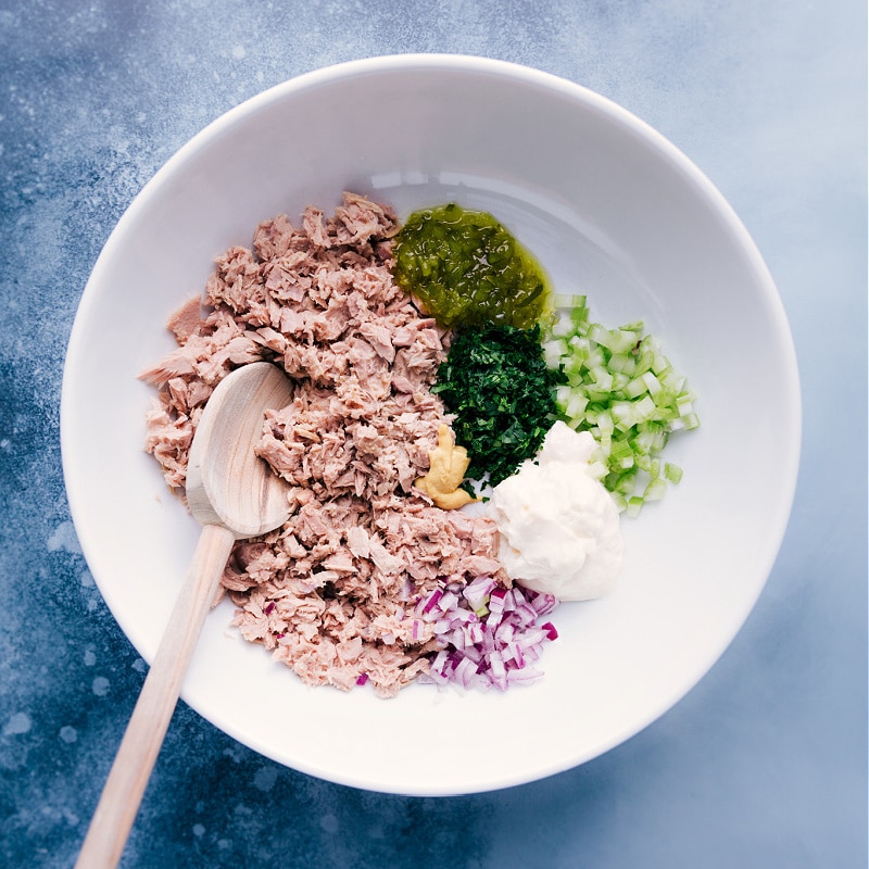 Overhead view of all the Tuna Salad ingredients in a bowl, ready to be combined.