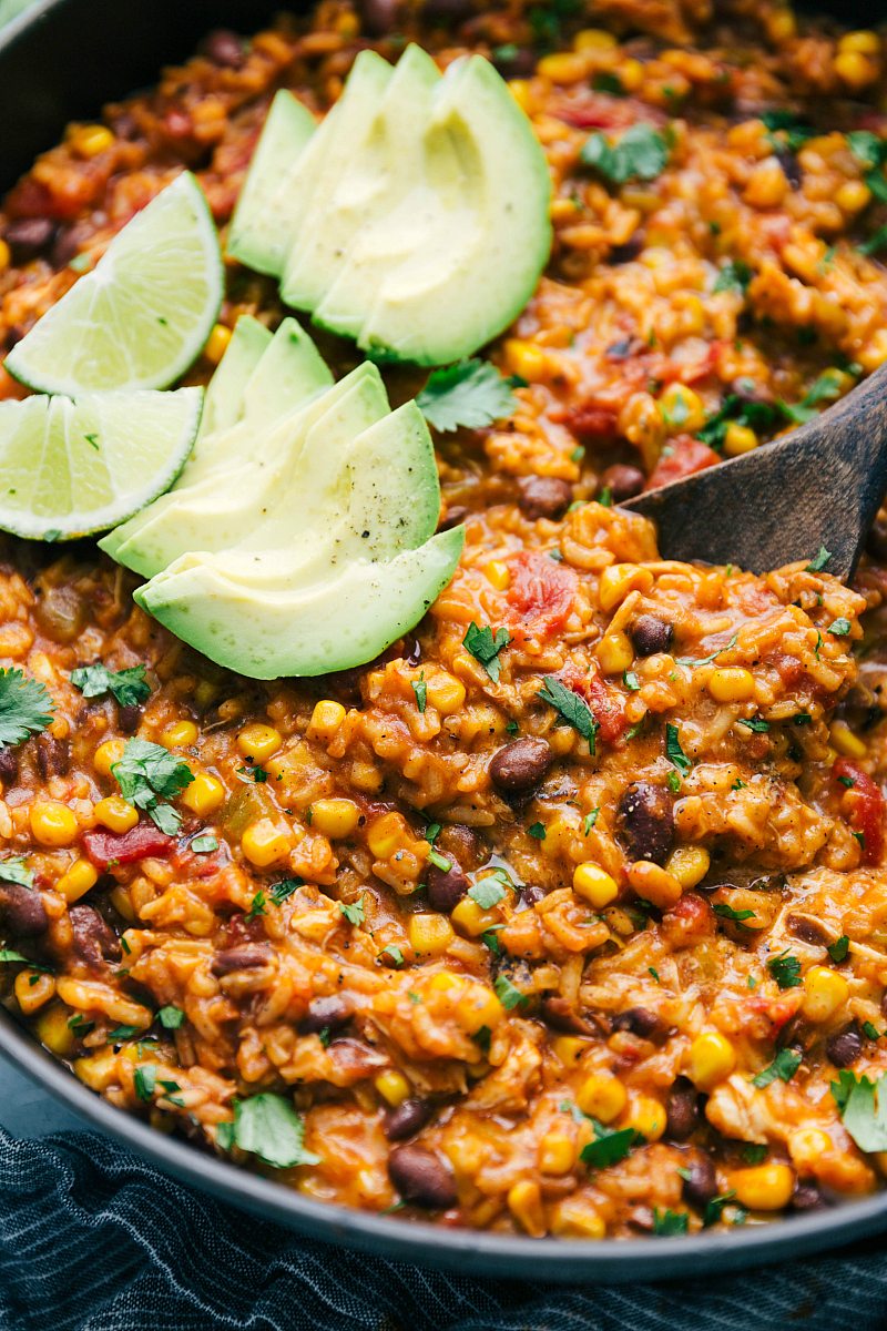 Close up shot of the one pot chicken burrito bowls with avocado and lime