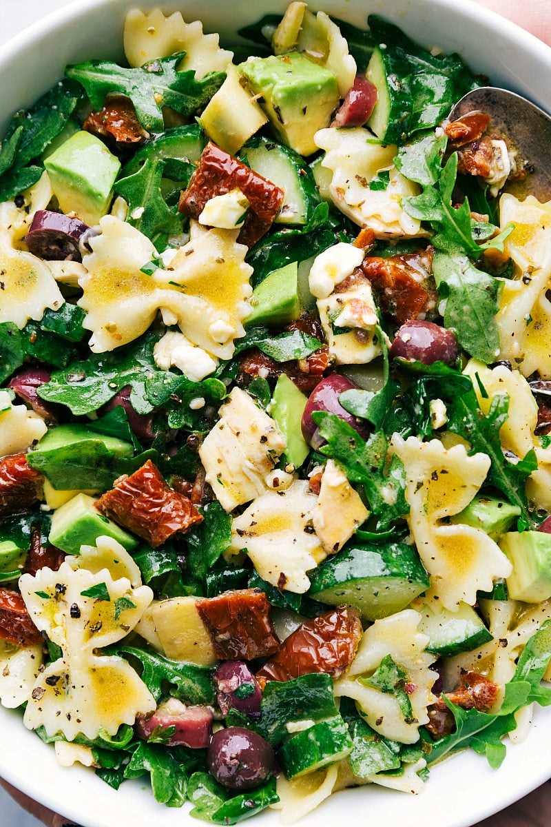 Close up of chicken pasta salad in a white bowl.