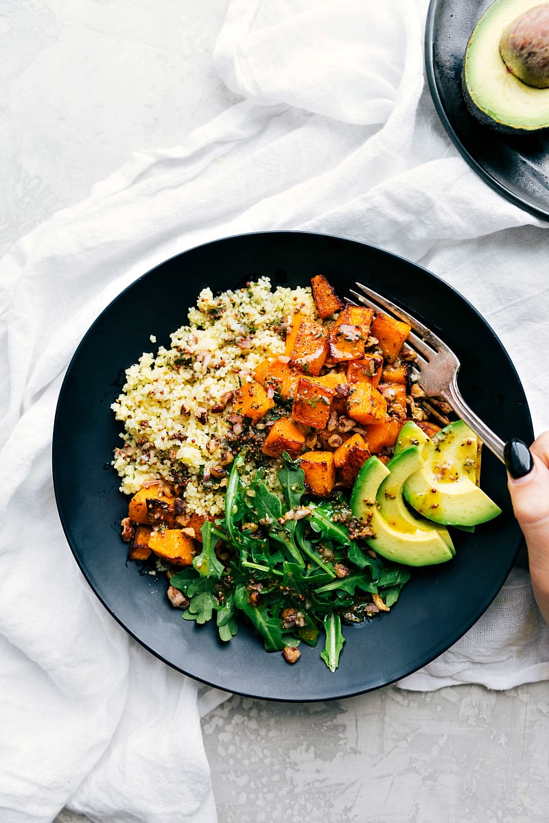 Plate with perfect roasted butternut squash, couscous, and the best dressing! A perfect healthy Fall meal