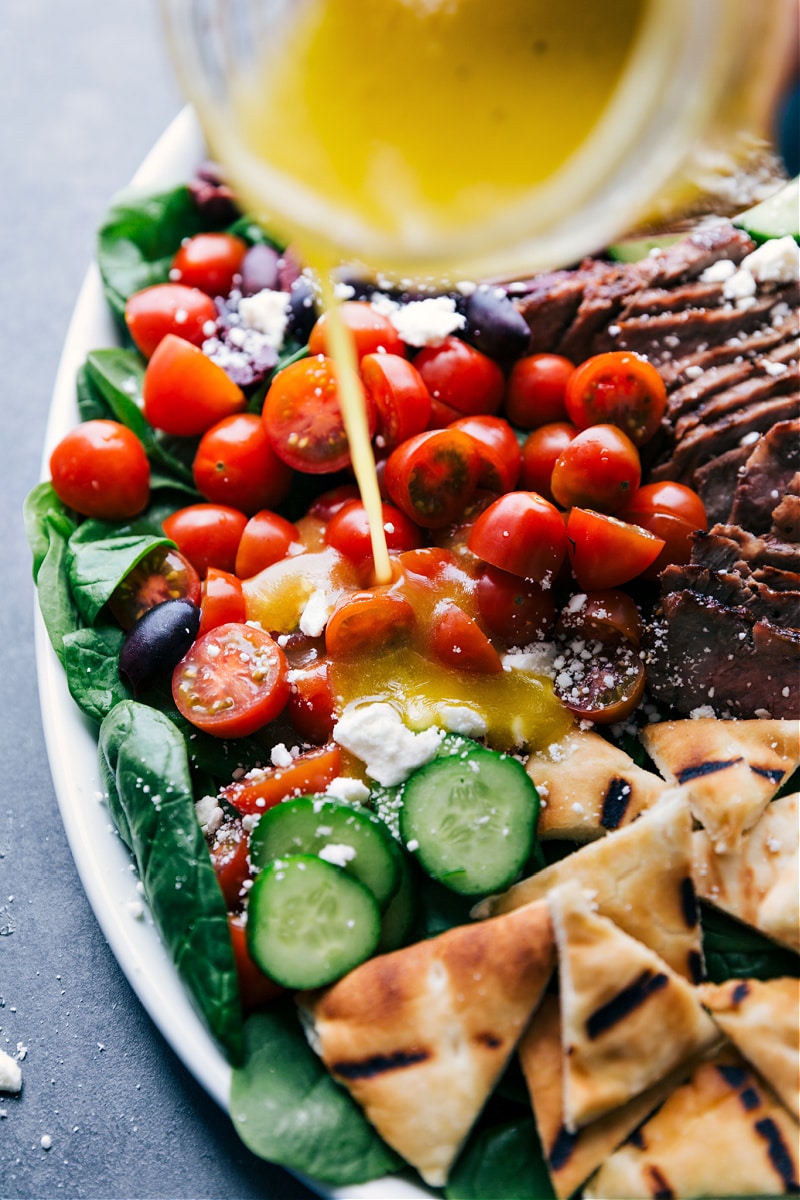 Image of the dressing being poured over the Grilled Steak Salad