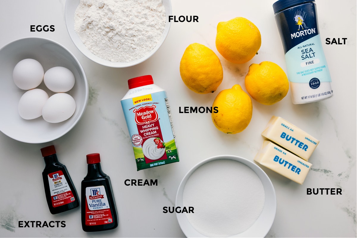 All the ingredients for lemon bars prepped and ready for easy assembly, including eggs, flour, salt, butter, sugar, cream, and extracts.
